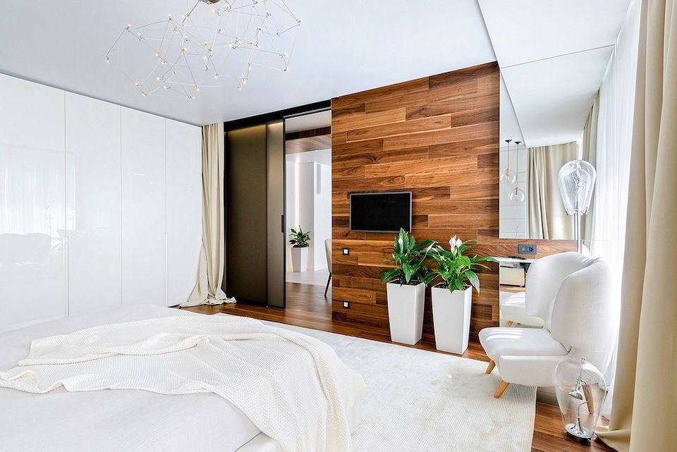 Раздвижные двери позволяют легко объединять спальню со студией. Большой платяной шкаф выглядит как отделанная панелями стена