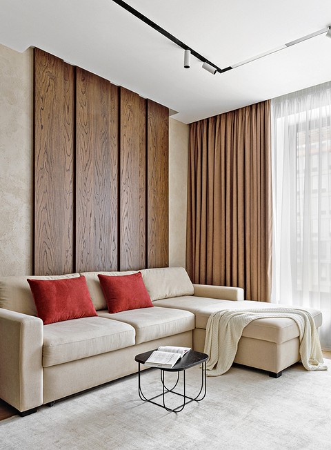 Декоративные шпонированные панели в диванной зоне поддерживают стилевое единство интерьера и помогают избежать монотонности в отделке.